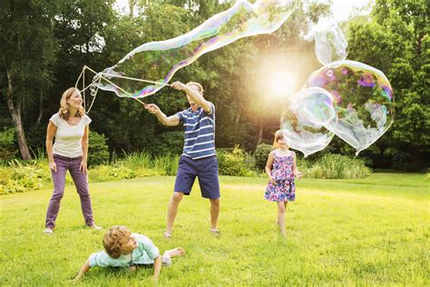 Family playing with large bubbles in backyard | Kaitlin Corporation ...