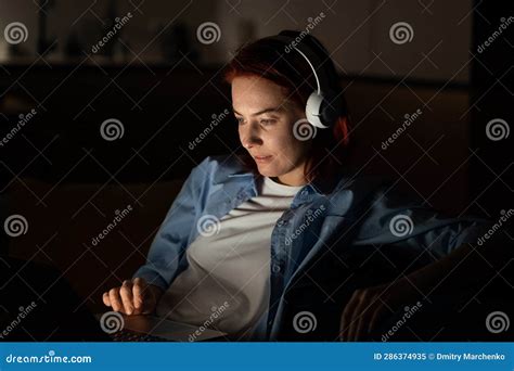 Concentrated Middle Aged Programmer Female Sits On Chair Work On Laptop