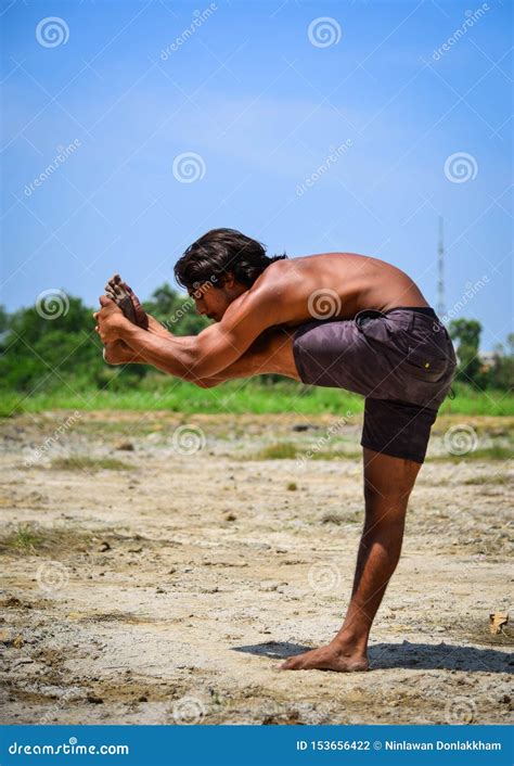 Young Indian Man Doing Yoga Exercise In The Park Editorial Photography