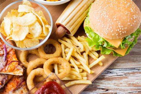 Close Up Of Fast Food Snacks On Wooden Table Stock Photo Image Of