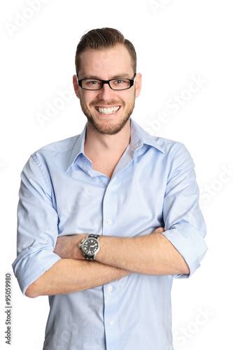A Handsome Man In His 20s Wearing A Blue Shirt And Glasses Smiling