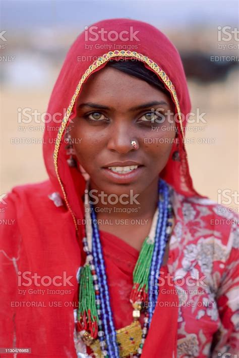 A Smiling Indian Woman Dressed In Traditional Rajasthani Clothing At