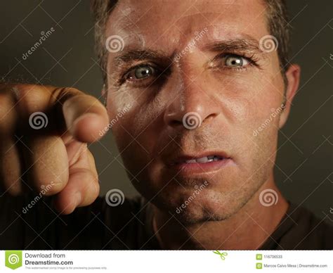 Close Up Portrait Of Young Angry And Upset Man Pointing With Finger As