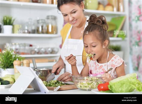 Mother And Daughter Cooking Together Stock Photo Alamy