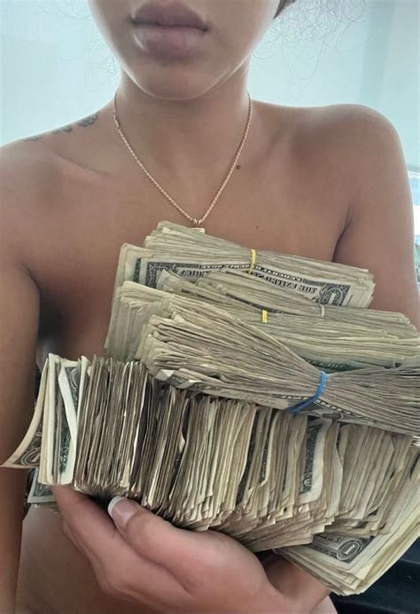 A Woman Holding Stacks Of Money In Her Hands