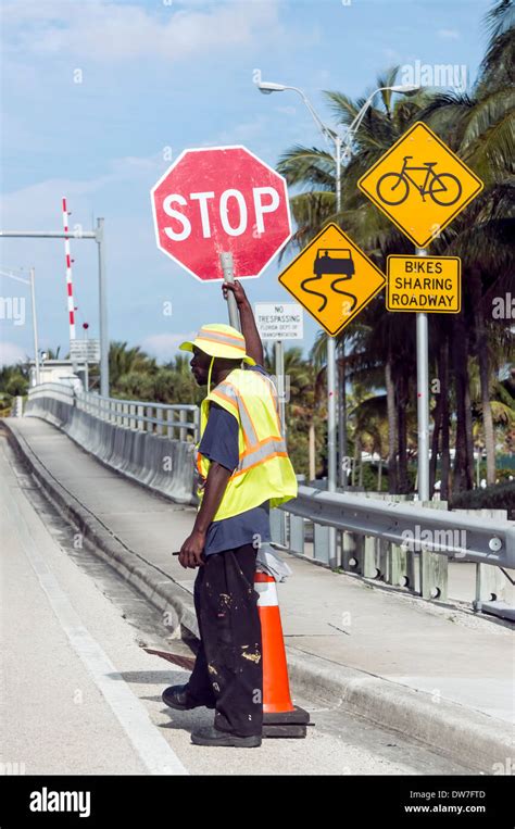 Flagman Holding Stop Sign Controls Traffic At Hillsboro Inlet Draw