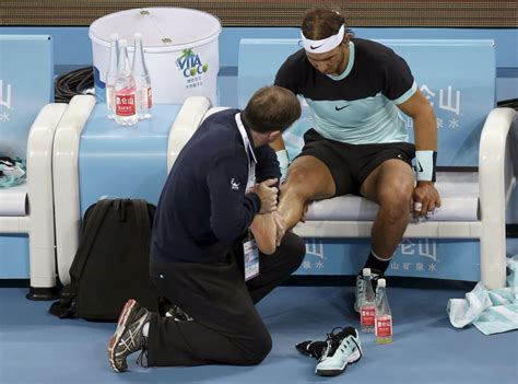 Nadal of Spain receives medical treatment on his foot during the men’s