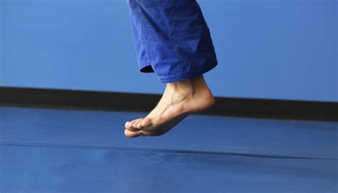 Feet Jumping Over Blue Sports Mat Performancetypes