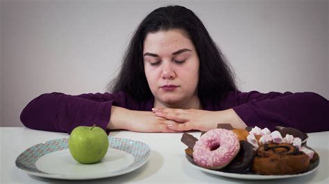 Fat Caucasian woman moving aside plate with apple and taking unhealthy ...