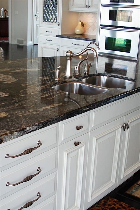 36 enviable black granite countertops with white cabinets. Titanium Granite Countertop White Cabinet Cream Backsplash Tile Dark Hardwood Floor in 2020 ...