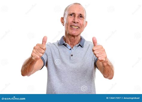 Studio Shot Of Happy Senior Man Smiling And Giving Thumbs Up Stock