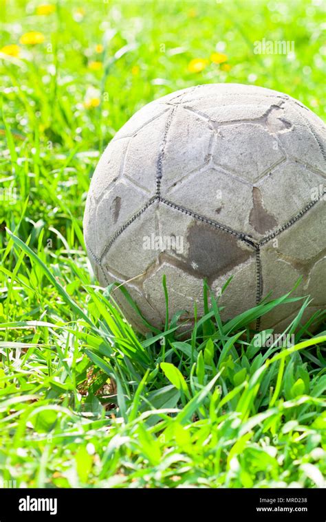 Old Soccer Ball Forgotten In The Green Grass Field The Football
