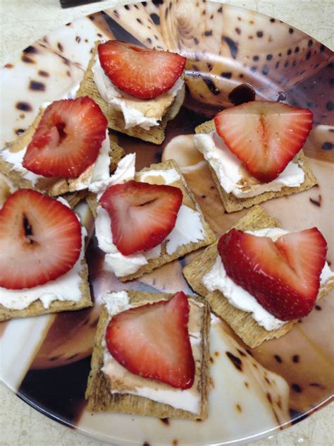 Strawberries Are Arranged On Crackers With Cream Cheese