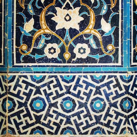 An Intricately Decorated Wall With Blue And White Tiles