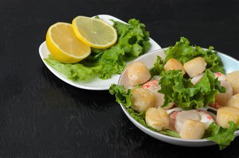 Fried Scallop With Boiled Shrimp Tail With Lettuce Leaves And Lemon In