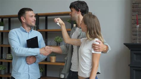 Happy Couple Receiving Apartment Key From Real Estate Agent Happy