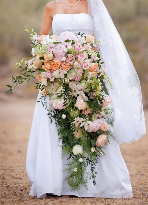 These sweeping streams of blooms add drama and personality to any wedding day look. 32 Chic Cascading Wedding Bouquets | Martha Stewart Weddings
