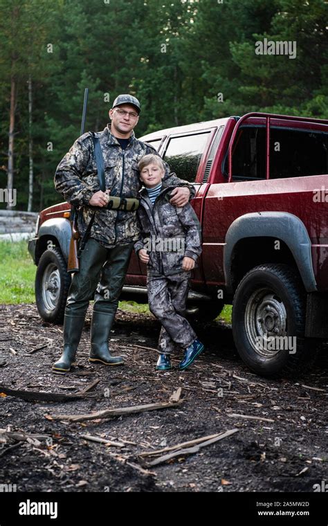 Father And Son Came To The Forest For Hunting Together Standing With A