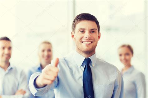Smiling Businessman Showing Thumbs Up In Office — Stock Photo © Syda