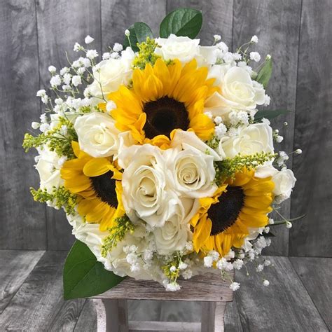 The first decision you will have to make is whether you want a silk arrangement or live. Sunflowers and white roses look beautiful in a bridal ...