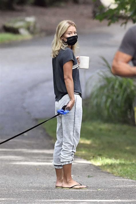 Kelly Ripa In A Black Tee Walks Her Dog Out With Her Husband Mark