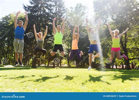 Group Of Happy Friends Jumping High Outdoors Stock Image Image Of