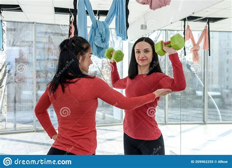 Training Together Portrait Of Two Fit Young Women Exercising On