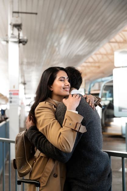 Free Photo Medium Shot Happy Couple Hugging At Airport