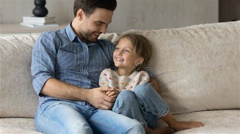 Happy Loving Dad Cuddling Hugging Little Daughter On Couch Stock Image Image Of Laugh