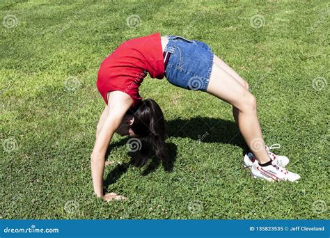 Young Woman Bending Over Backwards On Green Grass Stock Image Image
