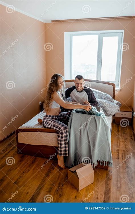 Happy Young Couple Is Having Fun In Bed In New Empty Home Passionate