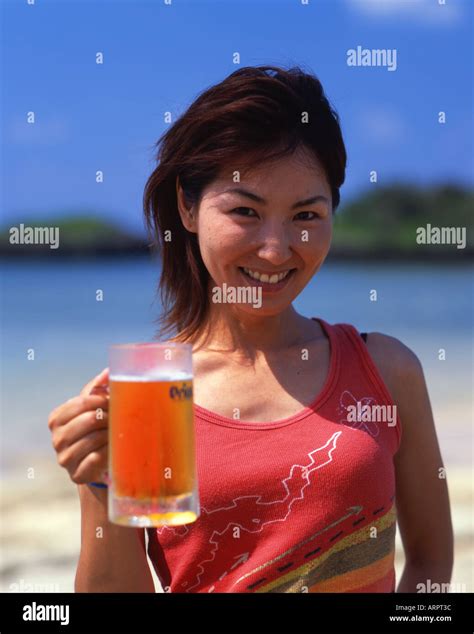 Beautiful Japanese Girl Stands On Hoshizuna Beach With Mug Of Orion Beer Iriomote Island