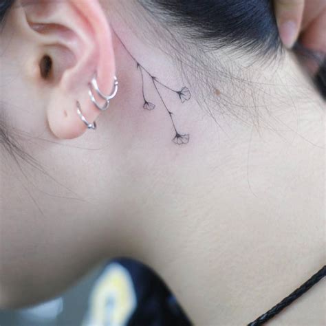 Little Flower Tattoo Behind The Left Ear