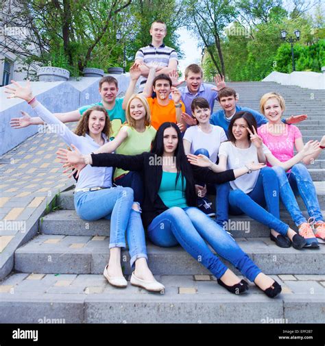 Group Of Smiling Teenagers Sitting On The Stairs Stock Photo Alamy