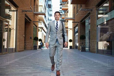 Businessman Walking To Work Along City Street Stock Photo Dissolve