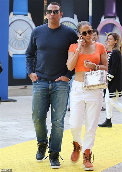 Jennifer Lopez Strolls Around Miami In An Orange Cropped Top With