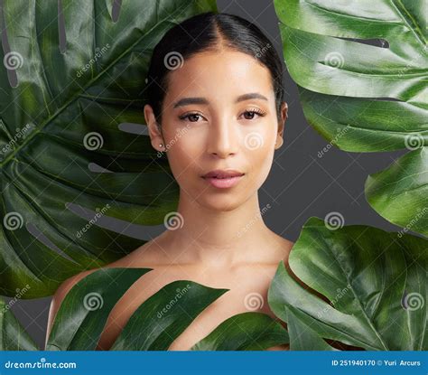 Studio Portrait Of A Beautiful Mixed Race Woman Posing With A Leaf