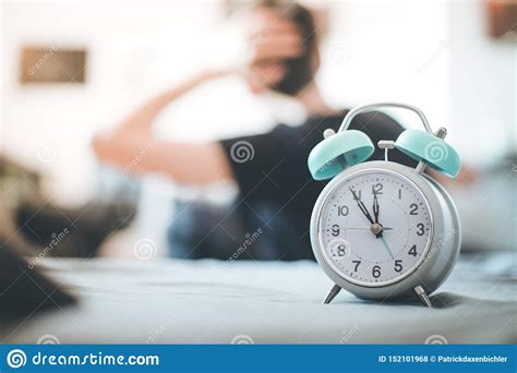 Alarm Clock In The Morning Young Wakes Up And Stretches In The Blurry