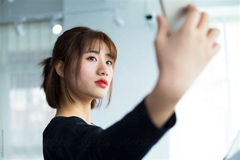 One Young Chinese Woman Talking Selfie In The Gym By Stocksy Contributor Bo Bo Stocksy
