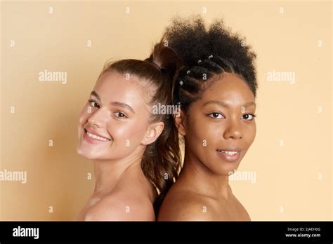 Portrait Of Two Young Multiracial Women With Perfect Moisturizing Skin Standing Together And