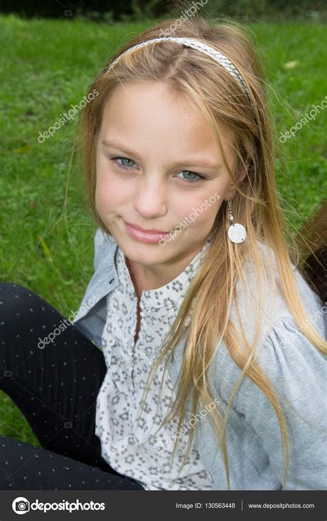Outdoor Portrait Of A Beautiful Blonde Girl Smiling Stock Photo By