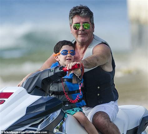 simon cowell s girlfriend lauren silverman sizzles in a swimsuit as their son eric goes jet