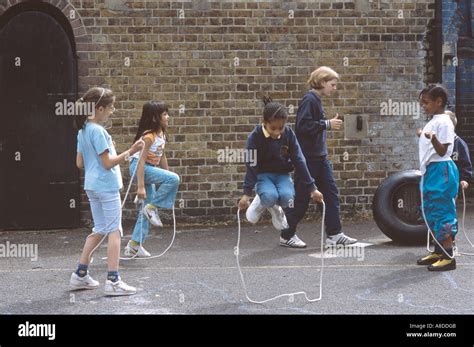 Primary School Playground With Girls Skipping Rope Stock Photo Alamy