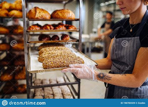 Baker Placing Tray With Freshly Baked Crispy Golden Croissants On A Shelf To Cool Stock Image