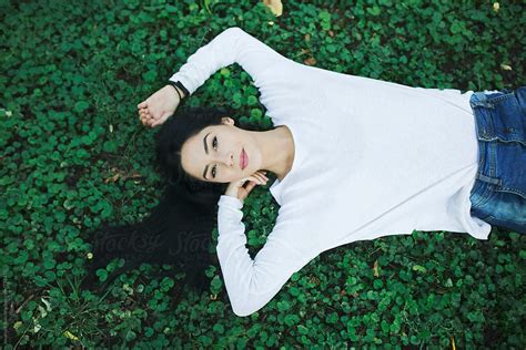 Beautiful Young Woman Lying On Grass And Smiling By Stocksy Contributor Jovana Rikalo Stocksy