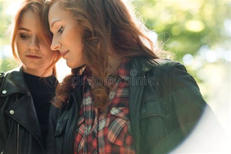 two lesbian girls in the shower shower head with pouring water and a female hand stock image