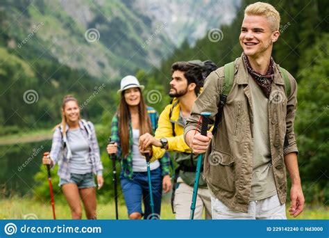 Group Of Friends Hiking Together Outdoors Exploring The Wilderness And