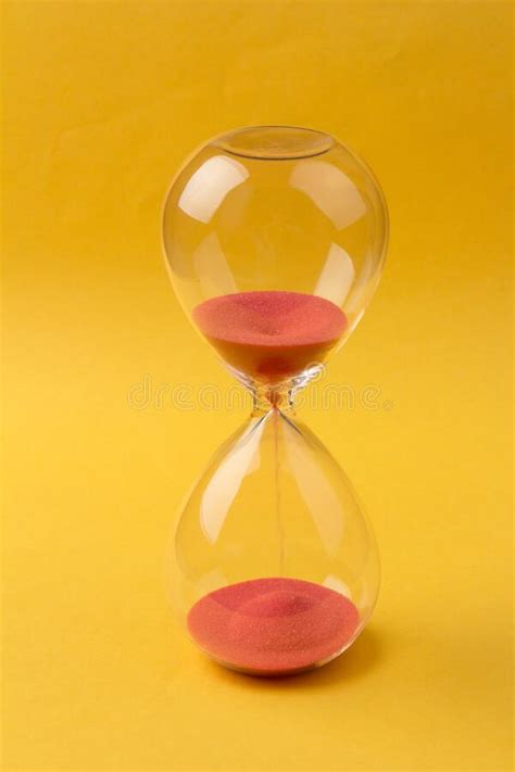Time Passing Concept Crystal Hourglass With Red Sand And Calendar On