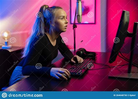 Focused Blonde E Sport Gamer Girl With Headset Playing Online Video