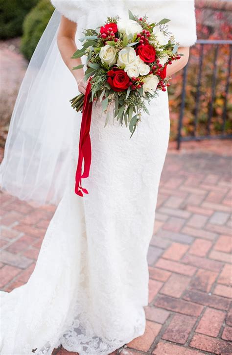 Berries were arranged with dahlias, zinnias, delphinium, clematis, and more for this rustic bouquet. Quintessential Red and White Christmas Wedding - Aisle Society